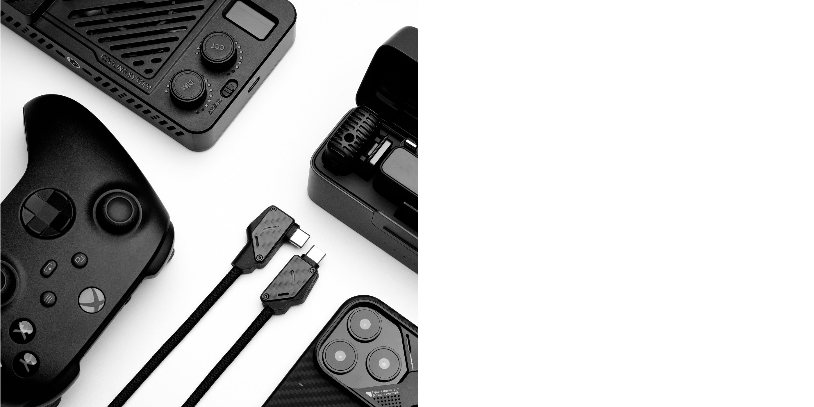 Flat lay of M07 USB-C cables with gaming controller and tech gear on white background