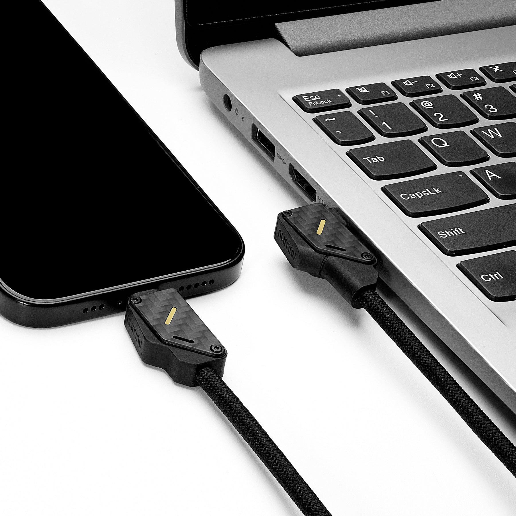 M07 carbon fiber USB-C cable connecting iPhone and laptop for fast data transfer